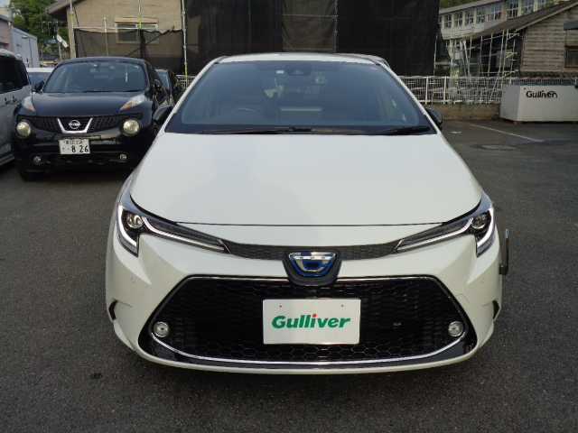 トヨタ カローラツーリング ハイブリッド ダブルバイビー 鹿児島県 2020(令2)年 6.3万km ホワイトパールクリスタルシャイン ワンオーナー/純正9インチディスプレイオーディオ/フルセグTV、ナビ、ブルートゥース/DVD、CD、バックカメラ/ヘッドアップディスプレイ/コムテック前後ドラレコ(ZDR-016)/ブラインドスポットモニター/レーダークルーズコントロール/前席左右シートヒーター/ステアリングヒーター/デジタルインナーミラー/オートハイビーム/ウッド調パネル/ビルトインETC/スマートキー2個あり/取説、ナビ取説、マルチメディア取説あり/保証書あり
