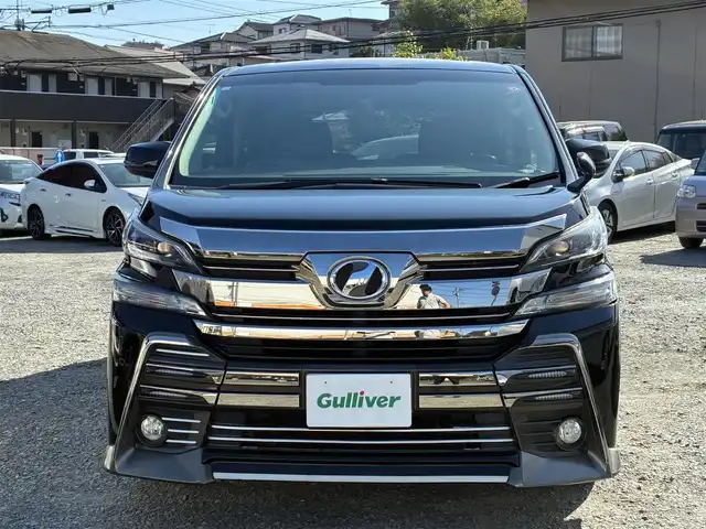 トヨタ ヴェルファイア Z 熊本県 2016(平28)年 9.3万km ブラック ALPINE専用ナビ/【フルセグTV/SD/CD/DVD/Bluetooth】/バックカメラ/ALPINEフリップダウンモニター/両側パワースライドドア/コーナーセンサー/社外20インチアルミホイール/ダウンサス/オートLEDヘッドライト/革調シートカバー/WAC/ビルトインETC/横滑り防止装置/盗難防止装置/純正フロアマット/ダブル＋サイドエアバック/プッシュスタート/スマートキー/スペアキー/三列シート/ウォークスルー/取扱説明書