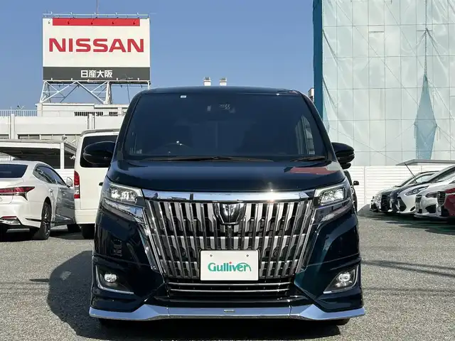 トヨタ エスクァイア Gi 兵庫県 2021(令3)年 3.9万km ブラッキッシュアゲハガラスフレーク ・モデリスタエアロ/・純正10インチナビ/・地デジ/DVD/BT/USB/HDMI/・ステアリングリモコン/・純正12.1型フリップダウンモニター（V12T-R68C）/・バックカメラ/・合皮シート/・前シートヒーター/・純正15インチAW/・オートLEDヘッドランプ/・LEDフォグランプ/・ビルトインETC/・両側パワースライドドア/・クルーズコントロール/・プリクラッシュセーフティ/・オートマチックハイビーム/・レーンディパーチャーアラート/・パーキングサポートブレーキ/・クリアランスソナー