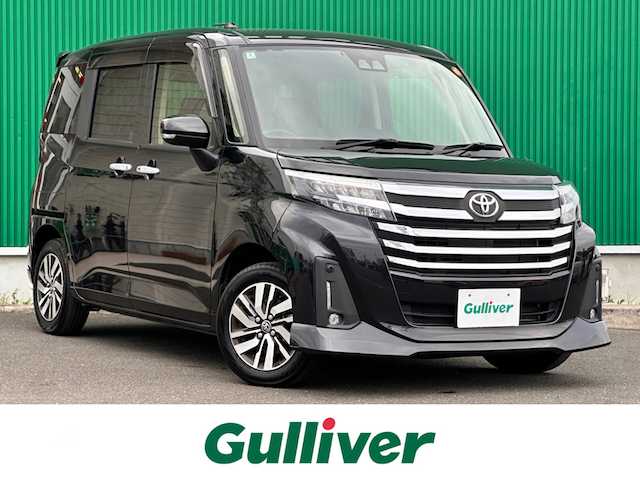 トヨタ ルーミー カスタムG 宮城県 2022(令4)年 1.7万km ブラックマイカメタリック コンフォートパッケージ/・シートヒーター（運転席/助手席）/・シートバックテーブル（運転席/助手席）/ナビレディパッケージ/・バックカメラ/・ステアリングスイッチ/＝＝＝/スマートアシスト/・衝突回避支援ブレーキ機能/・衝突警報/・車線逸脱警報機能/・ブレーキ制御付誤発進抑制機能/・先行車発進お知らせ機能/・アダプティブドライビングビーム/・アダプティブクルーズコントロール/・ふらつき警報/・サイドビューランプ/・コーナーセンサー/・路外逸脱警報/・標識認識機能/純正12インチフリップダウンモニター（V12T-R68C）/純正9インチナビ（NSZT-Y68T）/・CD/DVD/・Bluetooth/・フルセグTV/ビルトインETC2.0/ウェルカムパワースライドドア（運転席側/助手席側）/革巻きステアリング/電動パーキングブレーキ/ブレーキホールド/LEDヘッドランプ/フォグランプ/オートライト/スマートキー＆プッシュスタート/スペアキー/電動格納ミラー/純正14インチAW/純正ドアバイザー/純正フロアマット/Wエアバッグ