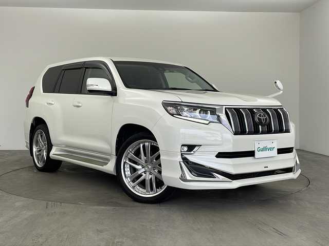 トヨタ ランドクルーザー プラド TX 兵庫県 2019(平31)年 3.3万km ホワイトパールクリスタルシャイン ・ALPINE9インチナビ/Bluetooth/CD/DVD/TV/SD/・バックカメラ/・Toyota Safety Sense/・プリクラッシュセーフティ/・レーンディパーチャーアラート［LDA］（ヨーアシスト機能付）/・オートマチックハイビーム［AHB］/・レーダークルーズコントロール（ブレーキ制御付）/・ロードサインアシスト［RSA］/・先行車発進告知機能［TMN］ /・VSC＆TRC（トラクションコントロール）/・ヒルスタートアシストコントロール（HAC）/・電動センターデフロック/・緊急ブレーキシグナル（ハザードランプ点滅） /・クリアランスソナー/・オートマチックハイビーム/・社外革調シートカバー/・サンルーフ/・社外ルームランプ/・防眩インナーミラー/・モデリスタエアロ/・WORK22インチアルミホイール/・社外サスペンション/・社外ウッドコンビステアリング/・LEDヘッドランプ［ハイ・ロービーム］/ オートレベリング機能付/・LEDクリアランスランプ（デイライト機能付）/・ヘッドランプクリーナー/・ビルトインETC/・前後ドライブレコーダー/・スペアキー