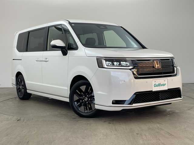 ホンダ ステップワゴン スパーダ eHEV 兵庫県 2025(令7)年 0.1千km プラチナホワイトパール ・登録済未使用車 距離5Km/・純正11.4インチナビ（LXM-247VFLi）/TV/Bluetooth/CD/DVD/USB/・純正15.6インチフリップダウンモニター（VM-231FE）/・バックカメラ/・Honda　SENSING/衝突軽減ブレーキ/先行車発進お知らせ機能/歩行者事故低減ステアリング/路外逸脱抑制機能/標識認識機能/アダプティブクルーズコントロール/車線維持支援システム/トラフィックジャムアシスト/ブラインドスポットインフォメーション/誤発進抑制機能/後方誤発進抑制機能/近距離衝突軽減ブレーキ/急アクセル抑制機能/パーキングセンサーシステム/オートハイビーム/・両側パワースライドドア/・パワーバックドア/・パドルシフト/・ハーフレザーシート/・全列USBチャージャー/・前席シートヒーター/・2列目オットマン/・LEDヘッドライト/・フォグランプ/・純正16インチアルミホイール/・スマートキー