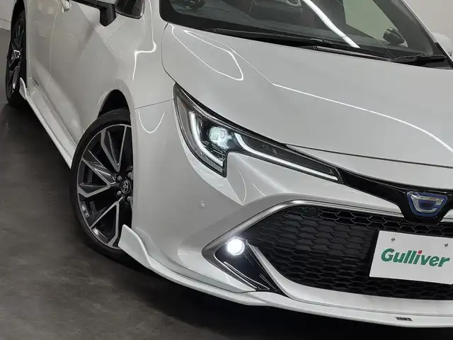 トヨタ カローラ スポーツ ハイブリッドG Z 三重県 2022(令4)年 1.6万km プラチナホワイトパールマイカ ハイブリッド/FF/フロアCVT/【OP】純正 9インチディスプレイオーディオ/（AM/FM/USB/iPod/Bluetooth/Miracast/AppleCarPlay/AndroidAuto）/バックガイドモニター/TOM’S スタイリングパーツセット（フロント、サイド、リヤバンパーディフューザー）/ビルトインETC/Toyota Safety Sense/●プリクラッシュセーフティ/●レーントレーシングアシスト/●レーダークルコン（全車速追従機能付）/●オートハイビーム/●ロードサインアシスト/・パーキングサポートブレーキ（前後静止物）/・【OP】ブラインドスポットモニター＋パーキングサポートブレーキ（後方接近車両）/・車両接近通報装置/装備/・【OP】本革＋ウルトラスエード ハーフレザーシート（運転席電動ランバーサポート付）/・シートヒーター（D/N）/・左右独立温度コントロールフルオートエアコン/・オートライト/・LED ヘッドランプ＆フロントフォグランプ/・電子パーキングブレーキ/・オートブレーキホールド/・ステアリングスイッチ/・プッシュスタート/・純正18inAW/・保/取/マルチ取/・スマートキーx2/など