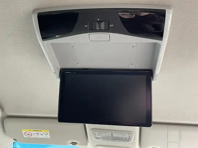 ホンダ フリード ハイブリット G ホンダセンシング 大阪府 2021(令3)年 4.9万km プラチナホワイトパール ホンダセンシング/ワンオーナー/純正9インチナビ/・フルセグTV/BT/USB/バックカメラ/11.6インチフリップダウンモニター/両側パワースライドドア/追従型クルーズコントロール/前ドライブレコーダー/ETC/純正フロアマット/ハーフレザーシート/革巻ハンドル/後席ロールサンシェード/純正15インチAW/取説・保証書/スペアキー/LEDヘッド