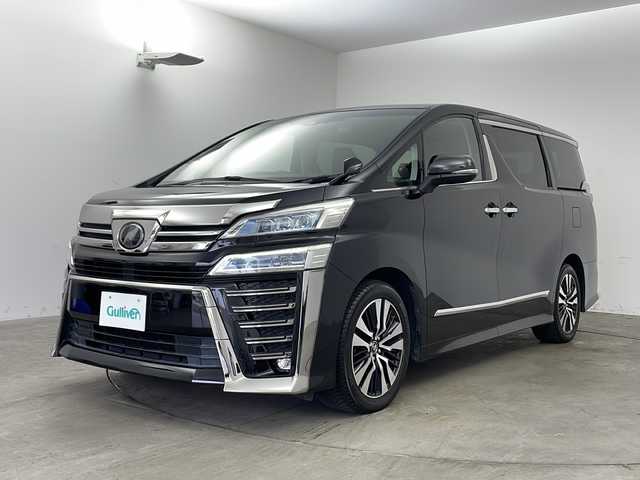 トヨタ ヴェルファイア Z Gエディション 兵庫県 2018(平30)年 7.7万km ブラック ・社外10インチSDナビ（AVIC-CE902VE）/・CD/DVD/BT/SD/フルセグTV/・バックカメラ/・ビルトインETC/・前後ドライブレコーダー/・社外レーダー探知機/・後席モニター２個（carrozzeria)/・両側パワースライドドア/・Toyota　Safety　Sense/・プリクラッシュセーフティ/・レーントレーシングアシスト/・レーダークルーズコントロール/・ロードサインアシスト/・オートマチックハイビームシステム/・クリアランスソナー/・パーキングサポートブレーキ/・デジタルインナーミラー/・ブラインドスポットモニター/・パワーバックドア/・合成皮革シート/・運転席メモリーシート/・前席パワーシート/・前席シートヒーター/・前席ベンチレーション/・ステアリングヒーター/・純正１８インチアルミホイール/・AC100V電源/・3眼LEDオートライト/・LEDフォグランプ/・社外フロアマット（後席部無し）/・シーケンシャルウィンカー/・スマートキー/・スペアキー/・プッシュスタート