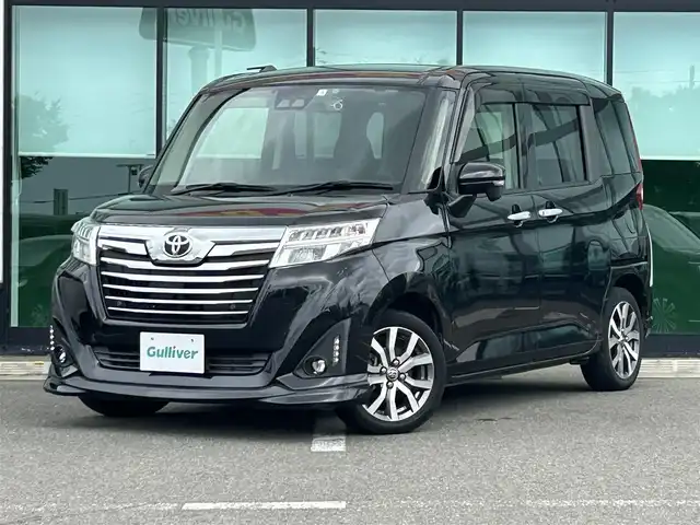 トヨタ ルーミー カスタムG－T 沖縄県 2020(令2)年 2.7万km ブラックマイカメタリック 純正ナビ/フルセグTV/バックカメラ/（BT/CD/DVD)/プリクラッシュセーフティー/クルーズコントロール/コーナーセンサー/横滑り防止装置/両側パワースライドドア/純正フロアマット/純正アルミホイール/アイドリングストップ/シートヒーター/革巻きステアリング/LEDヘッドライト/フォグランプ/オートライト/オートマチックハイビーム