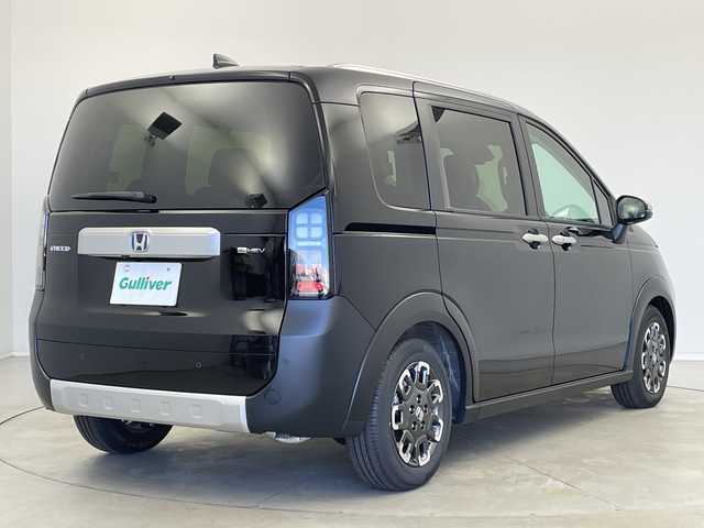 ホンダ フリード ハイブリット e:HEV クロスター 新潟県 2025(令7)年 0.1千km クリスタルブラックパール ホンダセンシング/9インチナビ（BT/CarPlay/AndroidAuto）/バックカメラ/両側パワースライドドア/シートヒーター/オートエアコン/オートライト/オートマチックハイビーム/衝突軽減システム/スマートキー/プッシュスタート/スペアキー/LEDヘッドライト/カーテンエアバック/ブラインドスポットモニター/レーンキープアシスト/保証書/取説/レザーステアリング/ステアリングスイッチ