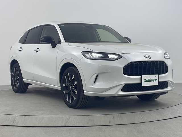 ホンダ ＺＲ－Ｖ ハイブリッド e:HEV Z 熊本県 2024(令6)年 0.6万km プラチナホワイトパール ワンオーナー/Honda CONNECT ディスプレー（メーカー標準９インチ）/フルセグTV/AppleCarPlay/AndroidAuto/Bluetooth/USB/iPod/全方位カメラ/ホンダセンシング/レーダークルーズコントロール/衝突被害軽減システム/ブラインドスポットモニター/前後コーナーセンサー/プレミアムサウンド（BOSE）/ワイヤレス充電/本革シート（黒色）/運転席・助手席シートヒーター・ステアリングヒーター/運転席・助手席パワーシート・シートメモリ/ビルトインETC2.0/電動パーキング・ブレーキホールド/MTモード付AT・パドルシフト/LEDヘッドライト/オートライト・オートマチックハイビーム/純正18インチハイビーム/純正フロアマット・Clazzio製フロアマット（防汚のため）/スマートキー/スペアキーあり/プッシュスタート/禁煙車