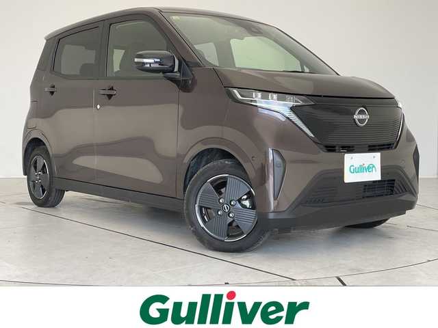 日産 サクラ X 愛知県 2023(令5)年 0.4万km アッシュブラウンM 純正9型ディスプレイオーディオ　ナビ機能なし/バックカメラ/コーナーセンサー/純正アルミホイール/LEDヘッドライト/オートライト/ETC/衝突軽減システム/Bluetooth/ステアリングスイッチ/スマートキー/プッシュスタート