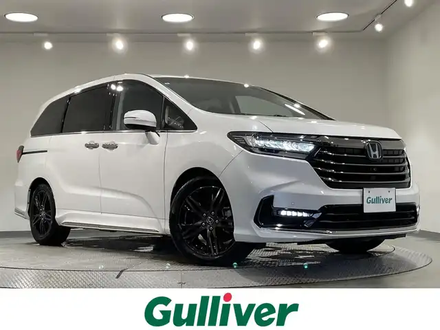 ホンダ オデッセイ ハイブリッド e:HEVアブソルート EX 愛知県 2021(令3)年 4.4万km プラチナホワイトパール 純正１０インチGathersナビ　/(CD・DVD再生/FM/AM/SD/フルセグTV/Bluetooth/USB/CarPlay)/マルチビューカメラシステム　/ホンダセンシング/　　-衝突軽減ブレーキ〈CMBS〉/　　-路外逸脱抑制機能/　　-誤発進抑制機能/　　-先行車発進お知らせ機能/　　-標識認識機能　/　　-レーダークルーズコントロール　/ブラインドスポットインフォメーション/両側パワースライドドア　/シートヒーター　/ビルトインＥＴＣ２．０　/電動バックドア　/D席/N席パワーシート/コーナーセンサー/ドライブレコーダー/オットマン