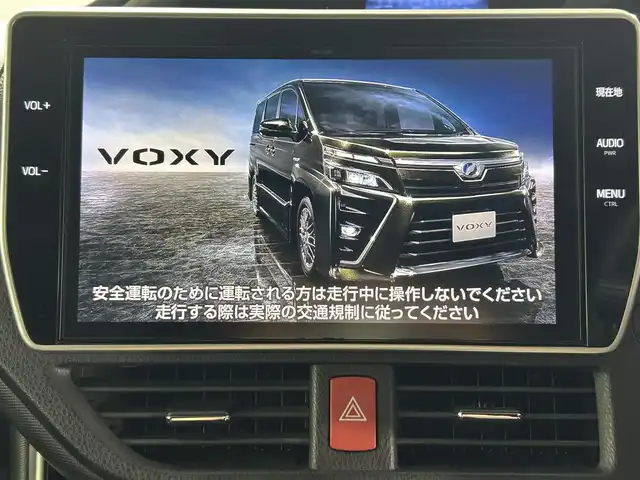 トヨタ ヴォクシー ハイブリッド ZS 煌 佐賀県 2018(平30)年 4.9万km ブラック 純正10.5インチナビ/AM/FM/CD/DVD/SD/Bluetooth/フルセグTV/スマートキー/スペアキー/クルーズコントロール/バックカメラ/ETC/前後ドライブレコーダー/ウォークスルー/純正フロアマット/シートヒーター/両側パワースライドドア/純正16インチAW/横滑り防止装置/先行者発進告知機能/レーンキープアシスト/プリクラッシュセーフティ/オートライト/オートハイビーム/ステアリングリモコン/バイザー/電動格納ミラー