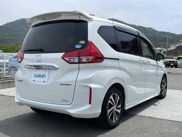 ホンダ フリード ハイブリット EX 山梨県 2016(平28)年 6.1万km ホワイトオーキッドパール 純正ナビ/ＥＴＣ/クルーズコントロール/シートヒーター/両側パワースライドドア　/ドライブレコーダー　/プッシュスタート/純正アルミホイール/オートマチックハイビーム/純正フロアマット/3列シート