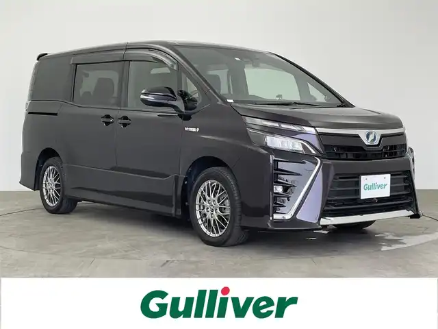 トヨタ ヴォクシー ハイブリッド ZS 大分県 2018(平30)年 6.5万km ボルドーマイカメタリック アルパイン11型ナビ(EX11Z)/CD　DVD　Bluetooth　フルセグ/社外フリップダウンモニター/バックカメラ/トヨタセーフティセンスC/衝突軽減ブレーキ/クルーズコントロール/両側パワースライドドア/前後ドライブレコーダー/ビルトインETC/シートヒーター前席/LEDオートライト/フォグランプ/純正フロアマット/純正16インチAW