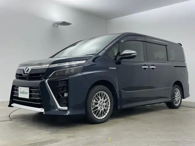 トヨタ ヴォクシー ハイブリッド ZS 煌Ⅱ 岡山県 2020(令2)年 4.9万km ブラッキッシュアゲハガラスフレーク 純正9インチナビ　/(Ｂｌｕｅｔｏｏｔｈ/フルセグＴＶ/CD/DVD)/衝突軽減ブレーキシステム/クルーズコントロール/オートハイビーム/ビルトインＥＴＣ/ＬＥＤヘッドライト/シートヒーター/前後ドライブレコーダー/バックカメラ/両側電動スライドドア/オートライト/フォグランプ/純正フロアマット/スマートキー×2/新車保証書/取扱説明書