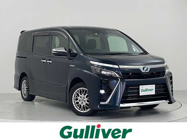 トヨタ ヴォクシー ハイブリッド ZS 煌Ⅱ 大阪府 2020(令2)年 4.9万km ブラッキッシュアゲハガラスフレーク トヨタセーフティセンス/・プリクラッシュセーフティ/・クルーズコントロール/・レーンキープアシスト/・オートマチックハイビーム/クリアランスソナー前後/純正9インチナビ　/　　CD/DVD/BT/TV/SD/バックカメラ/両側パワースライドドア/LEDヘッドライト/前席シートヒーター/革巻きステアリング/リヤオートエアコン/純正16インチアルミホイール/純正フロアマット/純正ビルトインETC/スマートキー
