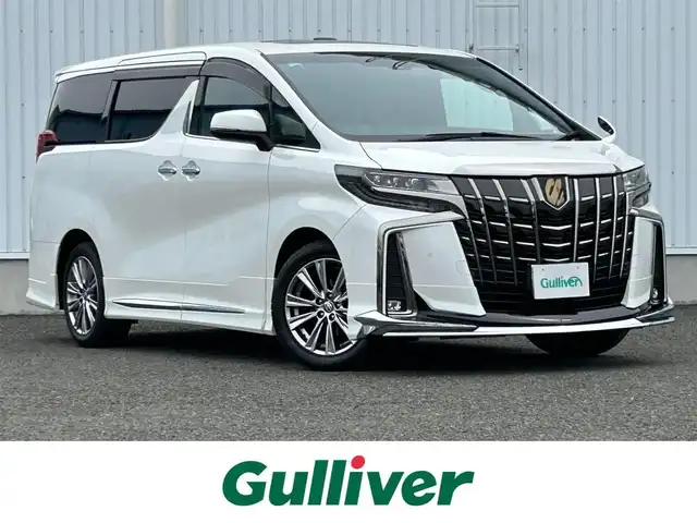 トヨタ アルファード S タイプゴールドⅡ 熊本県 2021(令3)年 2.1万km ホワイトパールクリスタルシャイン 純正ディスプレイオーディオ/・ナビキット/・フルセグTV/・AM/FM/USB/Bluetooth/・Miracast/・T-Connect/Smart DeviceLink/トヨタセーフティーセンス/・レーントレーシングアシスト/・クリアランスソナー/・パーキングサポートブレーキ/・プリクラッシュセーフティー/・ブラインドスポットモニター/・リアクロストラフィックアラート/・ロードサインアシスト/ビルトインETC2.0/ドライブレコーダー（前方）/ツインムーンルーフ/純正後席モニター/オットマン/ボタン式サイドブレーキ/ホールドブレーキ/デジタルインナーミラー/ステアリングスイッチ/革巻きステアリング/ウィンカーミラー/電動格納ミラー/ナノイー/MODELLISTAエアロパーツ/テレビキャンセラー/PWR DOOR OFFスイッチ/フォグランプ/ECOモード/純正フロアマット