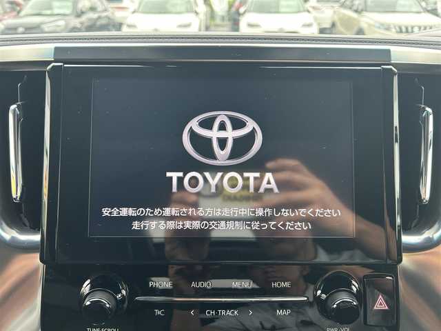 トヨタ アルファード S Cパッケージ 愛媛県 2021(令3)年 1.8万km ホワイトパールクリスタルシャイン 純正ナビ（Bluetooth/フルセグTV）/レーダークルーズコントロール/前後ドライブレコーダー/バックカメラ/USB入力端子/100V充電/三列シート/パワーシート/ステアリングヒーター/シートヒーター/エアシート/サンルーフ/オットマン/電動リアゲート/両側パワースライドドア/純正フロアマット/純正アルミホイール/前後コーナーセンサー/LEDヘッドライト/オートマチックハイビーム