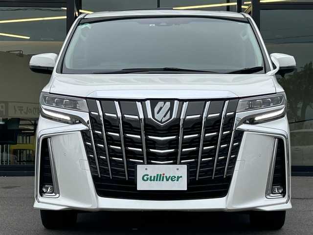 トヨタ アルファード S Cパッケージ 愛媛県 2021(令3)年 1.8万km ホワイトパールクリスタルシャイン 純正ナビ（Bluetooth/フルセグTV）/レーダークルーズコントロール/前後ドライブレコーダー/バックカメラ/USB入力端子/100V充電/三列シート/パワーシート/ステアリングヒーター/シートヒーター/エアシート/サンルーフ/オットマン/電動リアゲート/両側パワースライドドア/純正フロアマット/純正アルミホイール/前後コーナーセンサー/LEDヘッドライト/オートマチックハイビーム