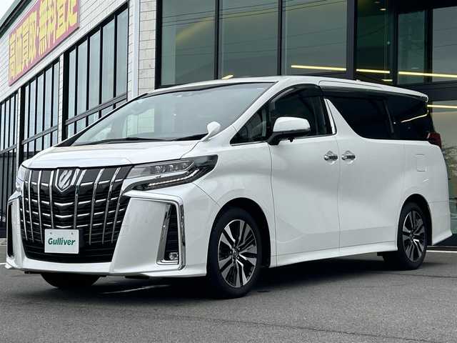 トヨタ アルファード S Cパッケージ 愛媛県 2021(令3)年 1.8万km ホワイトパールクリスタルシャイン 純正ナビ（Bluetooth/フルセグTV）/レーダークルーズコントロール/前後ドライブレコーダー/バックカメラ/USB入力端子/100V充電/三列シート/パワーシート/ステアリングヒーター/シートヒーター/エアシート/サンルーフ/オットマン/電動リアゲート/両側パワースライドドア/純正フロアマット/純正アルミホイール/前後コーナーセンサー/LEDヘッドライト/オートマチックハイビーム