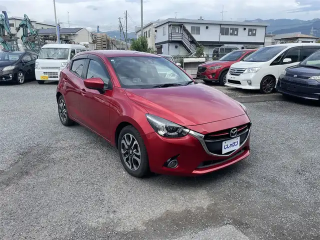 マツダ デミオ XD ツーリング 神奈川県 2015(平27)年 5.7万km ソウルレッドプレミアムメタリック (株)IDOMが運営する【じしゃロン秦野店】の自社ローン専用車両になりますこちらは現金またはオートローンご利用時の価格です。自社ローンご希望の方は別途その旨お申付け下さい/純正ナビ　/Bluetooth接続/バックカメラ/ETC/クルーズコントロール/純正アルミホイール/ドライブレコーダー/ヘッドアップディスプレイ