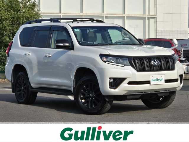 トヨタ ランドクルーザー プラド TX Lパッケージ マットブラED 鹿児島県 2023(令5)年 2.3万km ホワイトパールクリスタルシャイン ムーンルーフ/4WD/ストラーダナビ(Bluetooth/CD/DVD)/フルセグTV/バックカメラ/ビルトインETC/レーダークルーズコントロール/クリアランスソナー/セーフティセンス/・プリクラッシュセーフティ/・レーンディパーチャーアラート/・オートマチックハイビーム/・ロードサインアシスト/先行車発進告知機能/パーキングサポートブレーキ/トラクションコントロール/ヒルスタートアシストコントロール/LEDヘッドランプ/本革巻きステアリング/ニュートラルベージュ革シート/前席パワーシート/快適温熱シート/ルーフレール/ベースキャリア/純正18インチアルミホイール/スマートキー/スマートエントリー/スタートシステム/禁煙車
