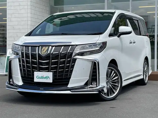 トヨタ アルファードハイブリット S タイプゴールド 道央・札幌 2020(令2)年 6.3万km ホワイトパールクリスタルシャイン ・４WD/・ワンオーナー/・衝突軽減ブレーキ/・サンルーフ/・モデリスタエアロ/・パーキングアシスト/・純正ナビ/　CD＆DVD＆BT＆TV/・バックカメラ/・全方位カメラ/・ブラインドスポットモニター/・パワーバックドア/・両側パワースライドドア/・フリップダウンモニター/・レーダークルーズコントロール/・コーナーセンサー/・レーンキープアシスト/・オートエアコン/・オートライト/・オートリトラミラー/・MT付きAT/・ビルトインETC/・JBLプレミアムサウンド/・三眼ライト/・プッシュスタート/・スマートキー/・クレンツェ20インチAW/・純正フロアマット/・ドアバイザー/・ウィンカーミラー/・フォグライト