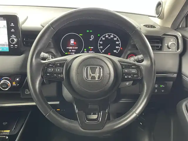 ホンダ ヴェゼル ハイブリッド e:HEV Z 大阪府 2021(令3)年 1.1万km プレミアムサンライトホワイトパール Moduloフロントグリル/18incAW ホンダセンシング シーケンシャル 純正9incナビTV 360カメラ ETC ハーフレザー シートヒーター 電動リアゲート 衝突軽減 レーダーC BSM 置くだけ充電