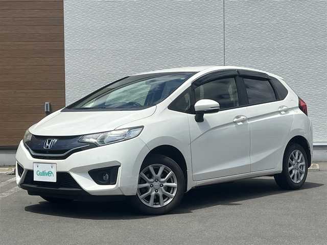 ホンダ フィット 13G Fパッケージ 秋田県 2015(平27)年 13.1万km プレミアムホワイトパール ４WD/純正ナビ/ワンセグ/バックカメラ/社外アルミ/スマートキー/アイドリングストップ/プッシュスタート/ステアリングスイッチ/ETC/純正フロアマット/純正ドアバイザー/オートエアコン/パワーステアリング/パワーウィンドウ/レベライザー/横滑り防止/電動格納ウィンカーミラー/保証書/取扱説明書/記録簿