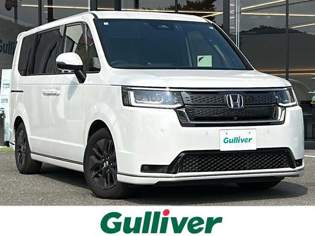 ホンダ ステップワゴン スパーダ eHEV 大阪府 2022(令4)年 6.1万km プラチナホワイトパール 衝突軽減　純正１１.4インチナビ フリップダウンモニター　両側パワースライドドア　ＢＳＭ　レーダークルーズコントロール　マルチビュー　プラズマクラスター　デュアルエアコン　運転支援　コーナーセンサー　電動リアゲート　前列シートヒーター　フルセグテレビ　オットマン　プッシュスタート　パワーバックドア　ETC　LEDヘッドライト　スマートキー　ハーフレザーシート