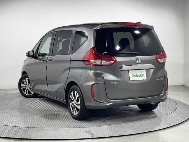 ホンダ フリード ハイブリット G ホンダセンシング 広島県 2021(令3)年 1.4万km スーパープラチナグレーメタリック 純正９型ナビ　/両側パワースライドドア　/後席モニター　/レーダークルーズコントロール　/フルセグ　/バックカメラ　/レーンキープアシスト　/衝突軽減ブレーキ　/コーナーセンサー　/オートライト　/ドラレコ　/ETC/純正15インチアルミホイール（185/65/R15)/エアバック（運転席/助手席）