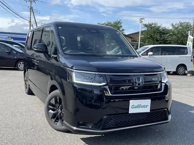 ホンダ ステップワゴン スパーダ 千葉県 2024(令6)年 0.5万km クリスタルブラックパール ワンオーナー/11.4インチ純正メモリナビ、地デジ、Bluetooth、CD、DVD/　（LXM-247VFNi）/バックカメラ/ホンダセンシング/パドルシフト/ウインカーミラー/革巻きステア/ハーフレザーシート/前席シートヒーター/両側パワースライドドア/パワーバックドア/レーダークルーズコントロール/W・サイド・カーテンエアバッグ/ETC/LEDヘッドライト/コーナーセンサー（前後）/２列目オットマン/ブラインドスポットインフォメーション/保証書、取説