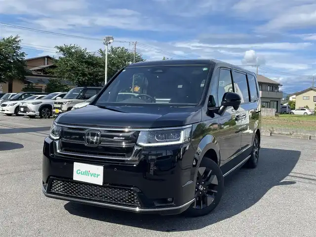 ホンダ ステップワゴン スパーダ 千葉県 2024(令6)年 0.5万km クリスタルブラックパール ワンオーナー/11.4インチ純正メモリナビ、地デジ、Bluetooth、CD、DVD/　（LXM-247VFNi）/バックカメラ/ホンダセンシング/パドルシフト/ウインカーミラー/革巻きステア/ハーフレザーシート/前席シートヒーター/両側パワースライドドア/パワーバックドア/レーダークルーズコントロール/W・サイド・カーテンエアバッグ/ETC/LEDヘッドライト/コーナーセンサー（前後）/２列目オットマン/ブラインドスポットインフォメーション/保証書、取説