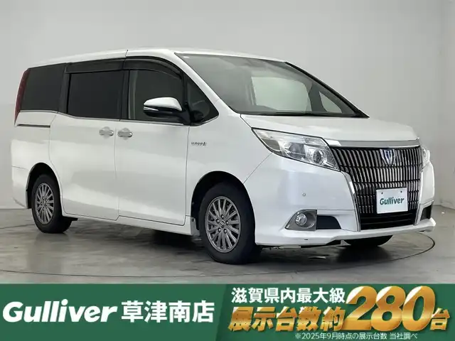 トヨタ エスクァイア ハイブリッド Gi 滋賀県 2014(平26)年 10万km ホワイトパールクリスタルシャイン 純正10型ナビ/Bluetooth/CD/DVD/フルセグTV/後席モニター/クルーズコントロール/前後ソナー/両側パワースライドドア/合皮シート/バックカメラ/シートヒーター/ETC/オートライト/スマートキー