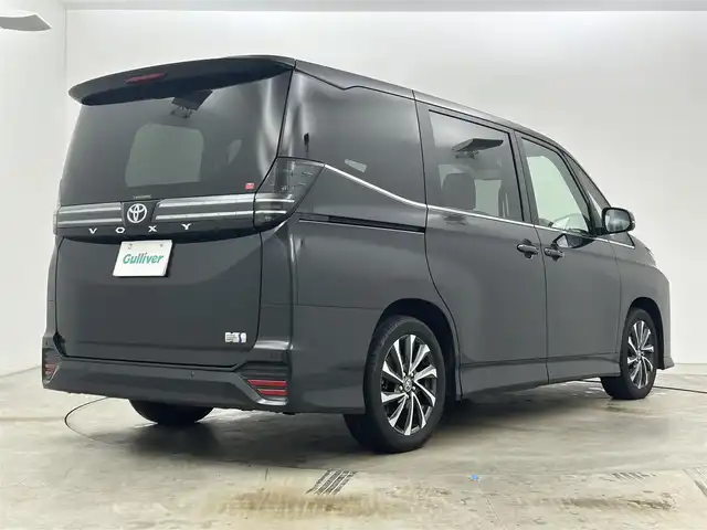 トヨタ ヴォクシー ハイブリッド S－Z 岡山県 2024(令6)年 1.9万km グリッターブラックガラスフレーク 快適利便パッケージ/ハーフレザーシート/純正10.5インチディスプレイオーディオ/　「ナビ/フルセグ/Bluetooth/DVD/ Carplay」/ブラインドスポットモニター/バックカメラ/ユニバーサルステップ（左回りのみ）/追従型クルーズコントロール/オートハイビーム/LEDヘッドライト/ビルトインETC2.0/両側パワースライドドア/シートヒーター(1列目/2列目)/衝突軽減ブレーキシステム/車線逸脱防止システム/横滑り防止装置/純正17インチアルミホイール/コーナーセンサー（前後）/純正フロアマット/ステアリングスイッチ/プッシュスタート/スマートキー×1