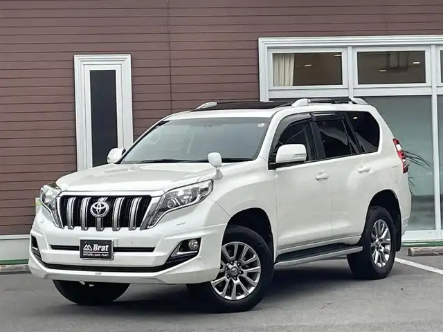 トヨタ ランドクルーザー プラド TXLパッケージ G－フロンティア 栃木県 2017(平29)年 7万km ホワイトパールクリスタルシャイン 【内装】/サンルーフ　/茶革シート　/前席パワーシート　/前席シートヒーター　/アルパイン 8型ナビ/CD/DVD/Blutooth/フルセグTV /バックカメラ　/アルパインフリップダウンモニター　/電動格納サードシート　/ドライブレコーダー/【外装】/モデリスタエアロ　/純正18インチアルミホイール　/サイドバイザー　