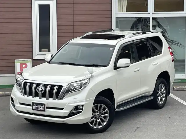 トヨタ ランドクルーザー プラド TXLパッケージ G－フロンティア 栃木県 2017(平29)年 7万km ホワイトパールクリスタルシャイン 【内装】/サンルーフ　/茶革シート　/前席パワーシート　/前席シートヒーター　/アルパイン 8型ナビ/CD/DVD/Blutooth/フルセグTV /バックカメラ　/アルパインフリップダウンモニター　/電動格納サードシート　/ドライブレコーダー/【外装】/モデリスタエアロ　/純正18インチアルミホイール　/サイドバイザー　