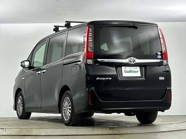 トヨタ エスクァイア ハイブリッド Gi 愛知県 2015(平27)年 6.8万km ブラック 禁煙車/純正9インチナビ/(Bluetooth CD DVD SD FM AM フルセグTV)/ワイヤレス充電/ルーフキャリア/バックカメラ/クルーズコントロール/車両接近通報装置/電動パーキングスイッチ/ビルトインETC/両側パワースライドドア/レザーシート/前席シートヒーター/ナノイー/純正フロアマット/純正15インチアルミホイール/HIDヘッドライト/フロントフォグランプ/Wエアコン/ISO FIX