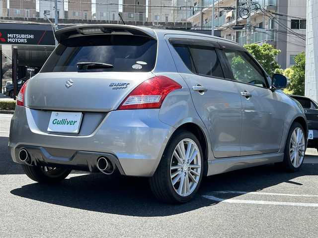 スズキ スイフト スポーツ 長崎県 2013(平25)年 5.1万km プレミアムシルバーメタリック 社外HDDナビ(FM/AM/BT/CD/DVD)/プッシュスタート/スマートキー/スペアキー(1本)/追従機能無しクルーズコントロール/ETC/バックカメラ/MTモード付AT/パドルシフト/ステアリングリモコン/前方ドラレコ/MonsterSport マフラー/ペダルカバー/フロアマット/純正17インチアルミホイール/ABS/ESP/オートライト/SRSダブルエアバッグ/フォグランプスイッチ/取扱説明書/保証書/記録簿/ナビ取扱説明書