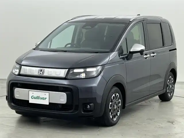 ホンダ フリード ハイブリット e:HEV クロスター 福岡県 2025(令7)年 0.1千km メテオロイドグレーメタリック 登録済未使用車　/純正ナビ（ＢＴ，フルセグＴＶ）　/バックカメラ　/ＡＣＣ　/コーナーセンサー　/衝突軽減ブレーキ　/レーンキープ　/ＢＳＭ　/先行車発進お知らせ　/両側電動スライドドア　/ハーフレザー　/シートヒーター
