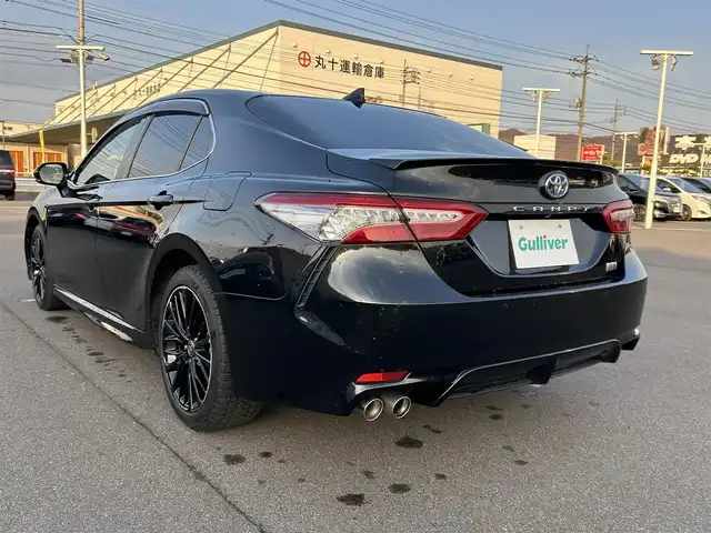 トヨタ カムリ WS ブラックエディション 岡山県 2021(令3)年 6.5万km プレシャスブラックパール 登録時走行距離65032km/純正ナビ/(AM.FM.BT)/バックカメラ/ETC2.0/ブラインドスポットモニター/シートヒーター/クリアランスソナー/衝突軽減ブレーキ/横滑り防止装置/クルーズコントロール(追従走行あり)/車線逸脱警報（レーンキープアシスト）/オートライト/オートマチックハイビーム/アイドリングストップ/電動リアゲート/18インチ純正AW/純正フロアマット/ハーフレザーシート/D+N席パワーシート