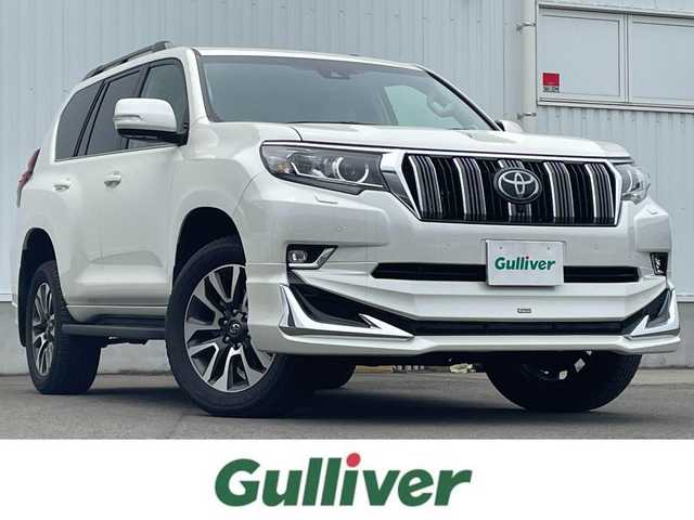 トヨタ ランドクルーザー プラド TX Lパッケージ 愛媛県 2023(令5)年 1.2万km ホワイトパールクリスタルシャイン ワンオーナー/トヨタセーフティー/純正ディスプレイオーディオ/（Bluetooth/AppleCarPlay/AndroidAuto)/アランドビューモニター/ビルドインETC2.0/サンルーフ/モデリスタエアロ/レザーシート/パワーシート/エアシート/シートヒーター/ルーフレール/アダプティブクルーズコントロール/プリクラッシュセーフティー/ブラインドスポットモニター/純正19インチアルミホイール/LEDヘッドライト/オートマチックハイビーム/ダウンヒルアシストコントロール/センターデフロック/スペアキー1本/取扱説明書/保証書