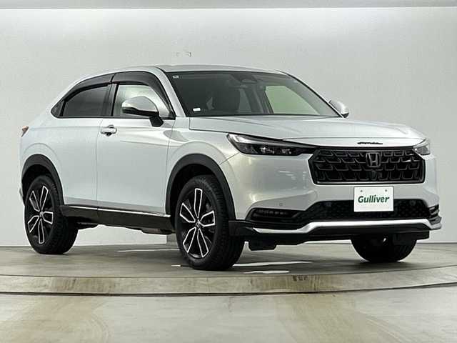 ホンダ ヴェゼル ハイブリッド e:HEV Z 愛知県 2024(令6)年 0.5万km プレミアムサンライトホワイトパール 禁煙車/純正9インチナビ/（AM/FM/Bluetooth/フルセグTV）/バックカメラ/ワイヤレス充電/ホンダセンシング/・衝突軽減ブレーキ/・誤発進抑制機能/・レーンキープアシスト/・オートマチックハイビーム/・追従式クルーズコントロール/コーナーセンサー/ETC2.0/ドライブレコーダー/シートヒーター/ステアリングヒーター/電動リアゲート/パドルシフト/ダウンヒルアシスト/LEDヘッドライト/スマートキー/純正アルミホイール