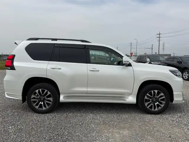 トヨタ ランドクルーザー プラド TX Lパッケージ 愛知県 2023(令5)年 5.1万km ホワイトパールクリスタルシャイン ワンオーナー/4WD/純正9型ナビ(BT/CD/DVD)/フルセグTV/バックカメラ/ビルトインETC/レーダークルーズコントロール/クリアランスソナー/セーフティセンス/・プリクラッシュセーフティ/・レーンディパーチャーアラート/・オートマチックハイビーム/・ロードサインアシスト/LEDヘッドランプ/木目調/革巻きコンビステアリング/ニュートラルベージュ革シート/前席パワーシート/快適温熱シート/3列目電動格納シート/純正19インチアルミホイール/スマートエントリー/スタートシステム/モデリスタエアロ/禁煙車