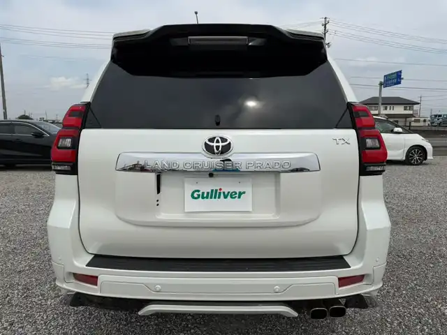トヨタ ランドクルーザー プラド TX Lパッケージ 愛知県 2023(令5)年 5.1万km ホワイトパールクリスタルシャイン ワンオーナー/4WD/純正9型ナビ(BT/CD/DVD)/フルセグTV/バックカメラ/ビルトインETC/レーダークルーズコントロール/クリアランスソナー/セーフティセンス/・プリクラッシュセーフティ/・レーンディパーチャーアラート/・オートマチックハイビーム/・ロードサインアシスト/LEDヘッドランプ/木目調/革巻きコンビステアリング/ニュートラルベージュ革シート/前席パワーシート/快適温熱シート/3列目電動格納シート/純正19インチアルミホイール/スマートエントリー/スタートシステム/モデリスタエアロ/禁煙車