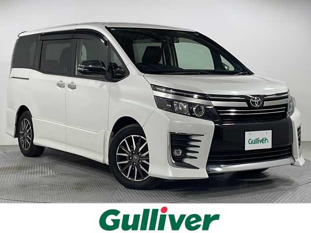 トヨタ ヴォクシー ZS 煌Ⅱ 広島県 2016(平28)年 6.5万km ホワイトパールクリスタルシャイン 禁煙　/社外９型ナビ　/両側パワースライドドア　/ブラインドスポットモニター/ＥＴＣ　/ドライブレコーダー　/後席モニター　/車線逸脱警報　/ＨＤＭＩ　/オートハイビーム　/衝突軽減システム　/ウォークスルー/社外16インチアルミホイール