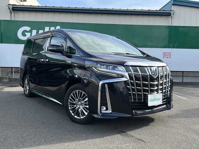 トヨタ アルファードハイブリット エグゼクティブ ラウンジ S 福島県 2021(令3)年 1.4万km スパークリングブラックパールクリスタルシャイン トヨタセーフティセンス/・衝突被害軽減ブレーキ/・オートハイビーム/・車線逸脱警報装置/・レーダークルーズコントロール/・ロードサインアシスト/・プロアクティブドライビングアシスト/純正ディスプレイオーディオナビ/・JBLサウンド/・フルセグTV/BT/CD/DVD/SD/USB/HDMI/・MiraCast/FM/AM/・バックカメラ/・アラウンドビューモニター/・ビルトインETC2.0/・純正フリップダウンモニター/前後ドライブレコーダー/・型番：DC-DR651/革張りステアリング/・ステアリングスイッチ/・ステアリングヒーター/レザーシート/・全席パワーシート/・全席シートヒーター/・全席エアシート/・オットマン/・3列シート/・D席メモリーシート/両側パワースライドドア/電動リアゲート/電子パーキング/・オートブレーキホールド/100V電源/MTモード付AT/プッシュスタート/・スマートキー/・スペアキー1本/LEDヘッドライト/・オートライト/・フォグランプ/コーナーセンサー/ワンオーナー/純正ドアバイザー/純正フロアマット/積込みスタッドレスタイヤ/・ECOFORMEアルミ/・溝10mm/・225/60R16