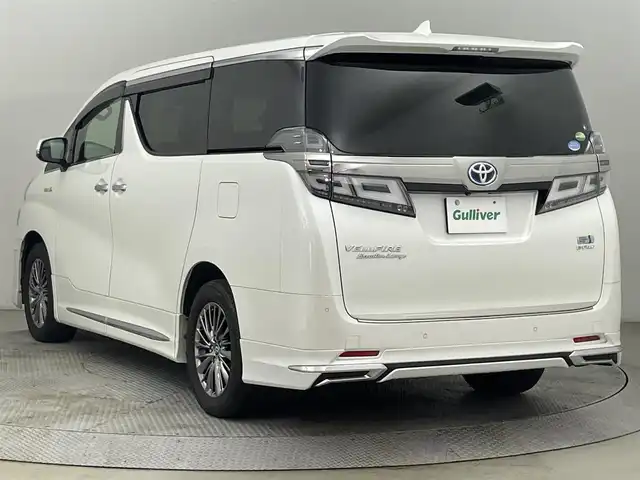 トヨタ ヴェルファイア ハイブリット エグゼクティブ ラウンジ 道央・札幌 2018(平30)年 11.1万km ホワイトパールクリスタルシャイン ・４WD/・寒冷地仕様/・モデリスタエアロ（F・S・R）/・JBLサウンド/・純正メーカーナビ/　CD／DVD／BT／フルセグ/・パノラミックビューモニター/・純正フリップダウンモニター/・デジタルインナーミラー/・純正ビルトインETC2.0/・社外ドライブレコーダー/・両側パワースライドドア/・トヨタセーフティセンス/・プリクラッシュセーフティ/・オートマチックハイビーム/・レーンキープアシスト/・レーントレーシングアシスト/・リヤクロストラフィックアラート/・パーキングサポートブレーキ/・ロードサインアシスト/・アダプティブフロントライティングシステム/・前後コーナーセンサー/・ベージュレザーシート/・全席シートヒーター/・全席シーエアコン/・全席パワーシート/・運転席シートメモリー/・純正AW17インチ/・LEDヘッドライト/・フォグライト/・純正フロアマット/・ドアバイザー/・スマートキー/・プッシュスタート/・スペアキー/・取扱説明書