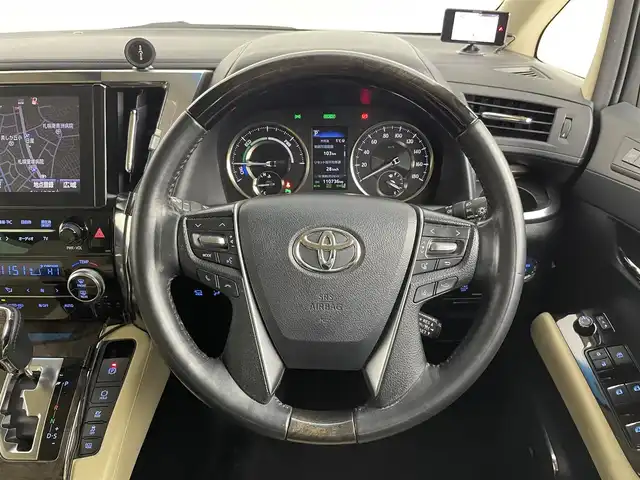 トヨタ ヴェルファイア ハイブリット エグゼクティブ ラウンジ 道央・札幌 2018(平30)年 11.1万km ホワイトパールクリスタルシャイン ・４WD/・寒冷地仕様/・モデリスタエアロ（F・S・R）/・JBLサウンド/・純正メーカーナビ/　CD／DVD／BT／フルセグ/・パノラミックビューモニター/・純正フリップダウンモニター/・デジタルインナーミラー/・純正ビルトインETC2.0/・社外ドライブレコーダー/・両側パワースライドドア/・トヨタセーフティセンス/・プリクラッシュセーフティ/・オートマチックハイビーム/・レーンキープアシスト/・レーントレーシングアシスト/・リヤクロストラフィックアラート/・パーキングサポートブレーキ/・ロードサインアシスト/・アダプティブフロントライティングシステム/・前後コーナーセンサー/・ベージュレザーシート/・全席シートヒーター/・全席シーエアコン/・全席パワーシート/・運転席シートメモリー/・純正AW17インチ/・LEDヘッドライト/・フォグライト/・純正フロアマット/・ドアバイザー/・スマートキー/・プッシュスタート/・スペアキー/・取扱説明書