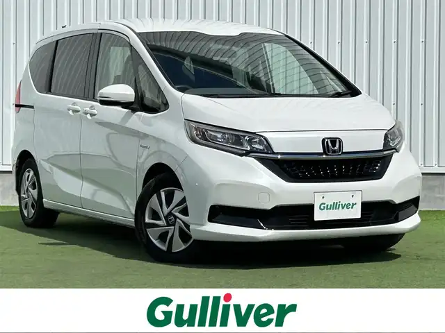 ホンダ フリード ハイブリット G ホンダセンシング 香川県 2020(令2)年 5.9万km プラチナホワイトパール 社外ナビ/・Bluetooth/・CD/DVD/・ワンセグTV/・USB/・SD/主要装備/・プッシュスタート/・両側パワースライドドア/・ETC車載器/・前席シートヒーター/・コーナーセンサー/・純正フロアマット/・オートライト/・LEDヘッドライト/・後席サンシェード/ホンダセンシング/・衝突軽減ブレーキ/・車線維持支援システム/・アダプティブクルーズコントロール/・誤発進抑制機能/・歩行者事故低減ステアリング/・路外逸脱抑制機能/・先行車発進お知らせ機能/・標識認識機能