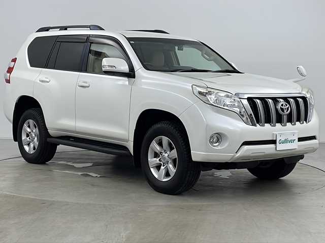 トヨタ ランドクルーザー プラド TX Lパッケージ 道央・札幌 2015(平27)年 8万km ホワイトパールクリスタルシャイン ・4WD/・社外ナビ(TV＆BT＆DVD＆CD)/・社外後席フリップダウンモニター/・バックカメラ/・レザーシート/・パワーシート/・シートヒーター/・クルーズコントロール/・横滑り防止/・純正ビルトインETC/・ドアミラーウィンカー/・オートライト/・フォグランプ